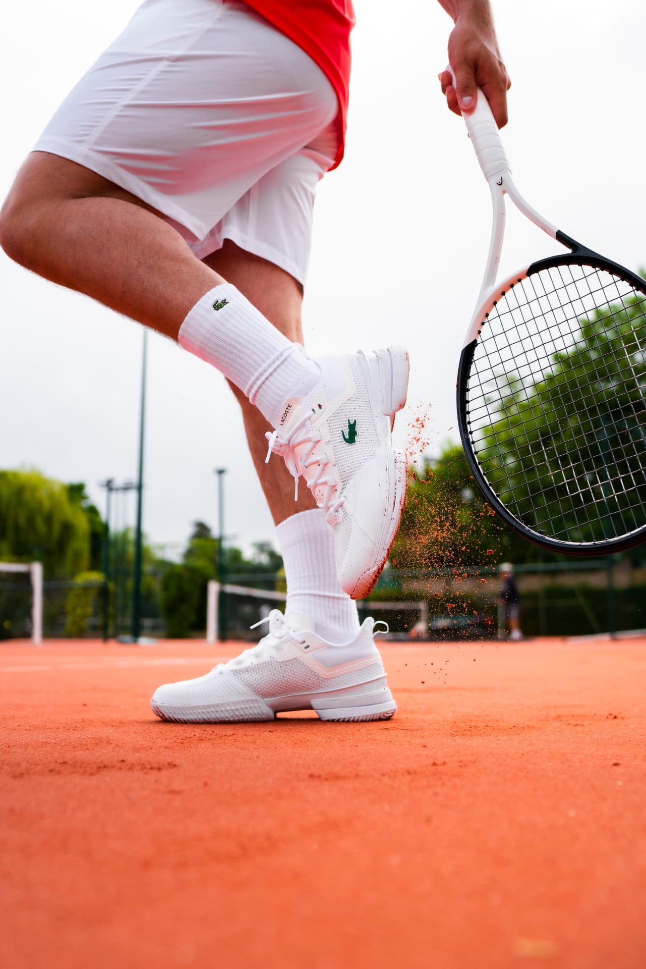 Competitive tennis player changing direction on a clay court